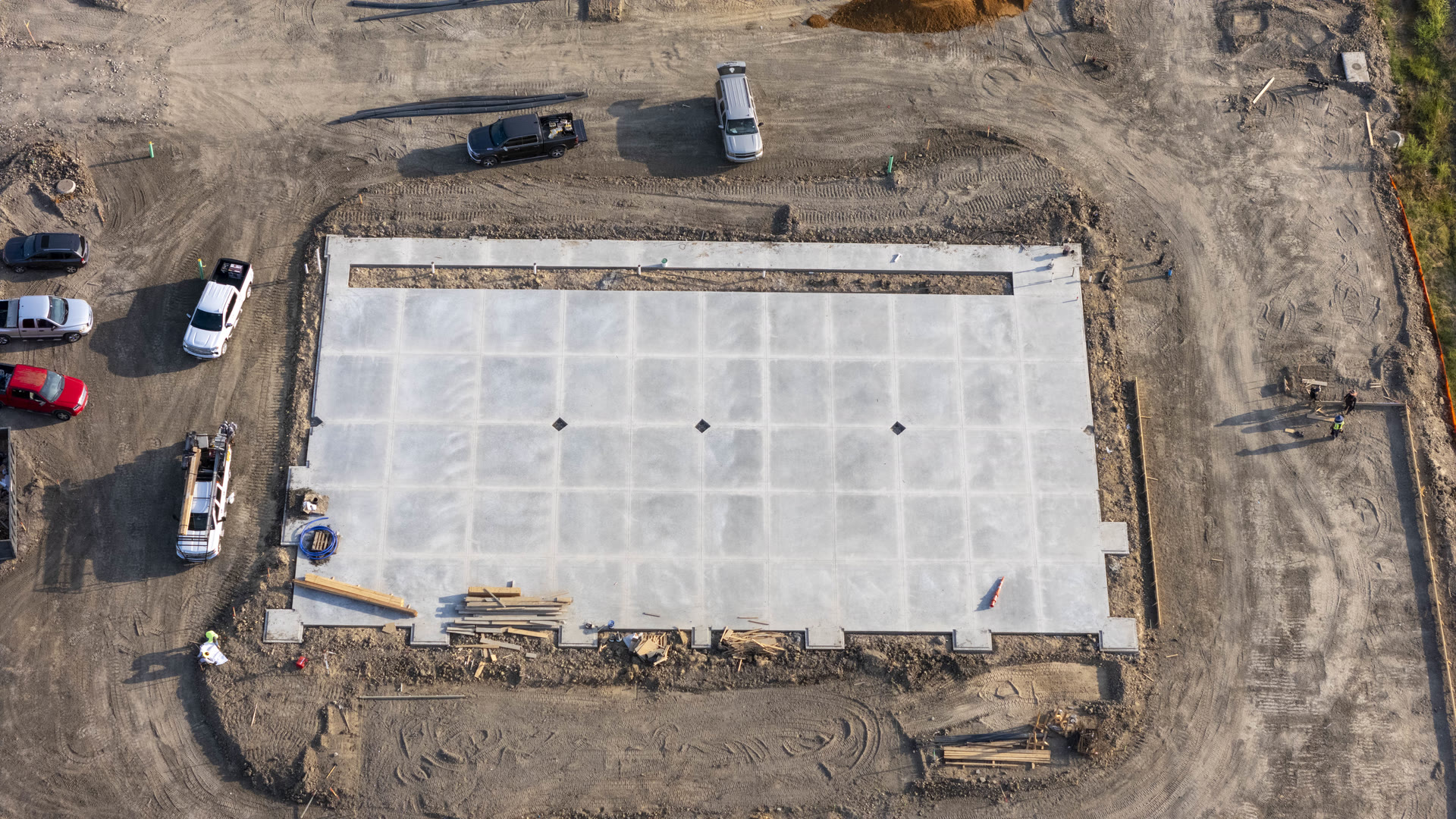 Top-down aerial view of a newly poured construction foundation